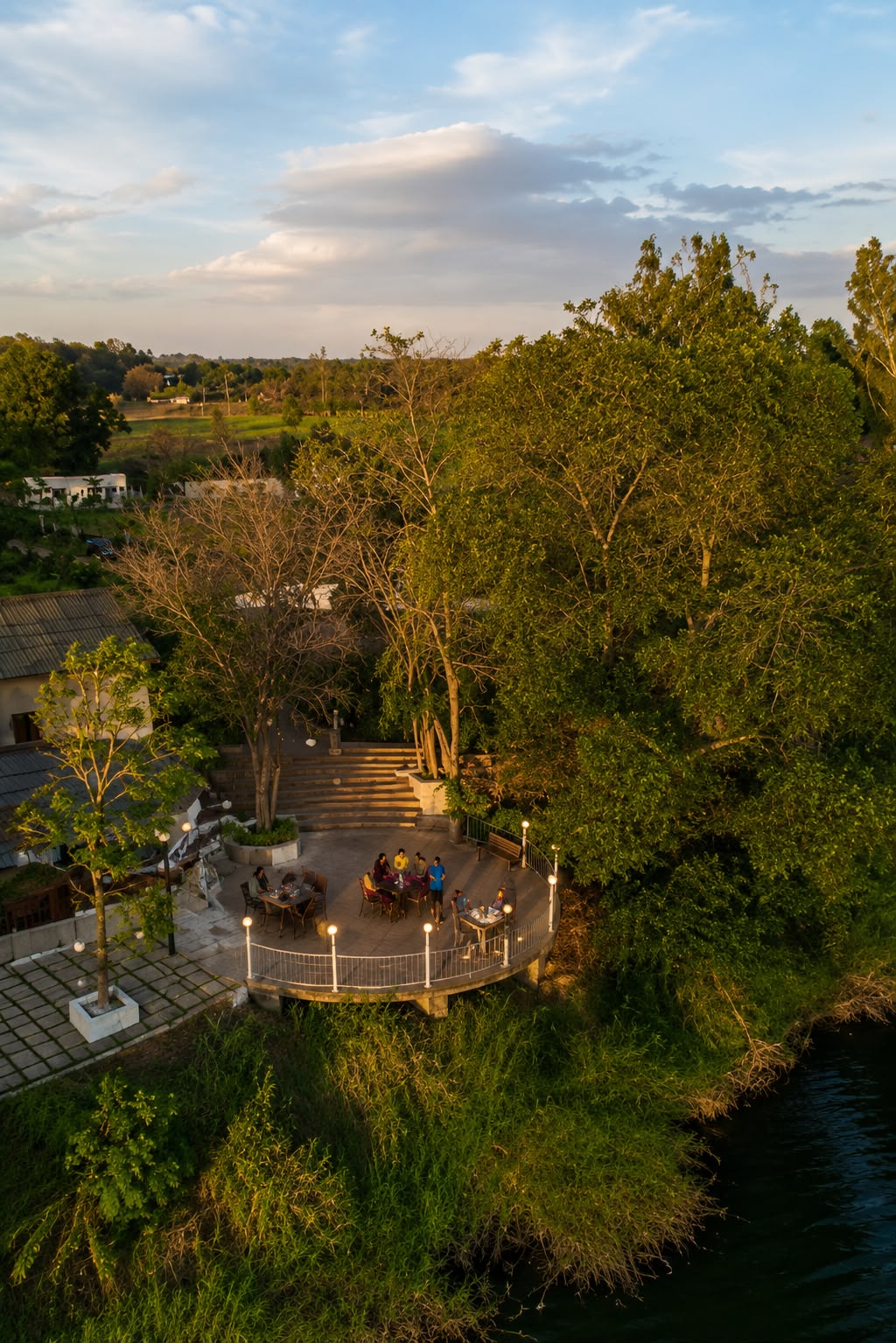 Riverside terrace surrounded by trees at Fortune Woods Dandeli