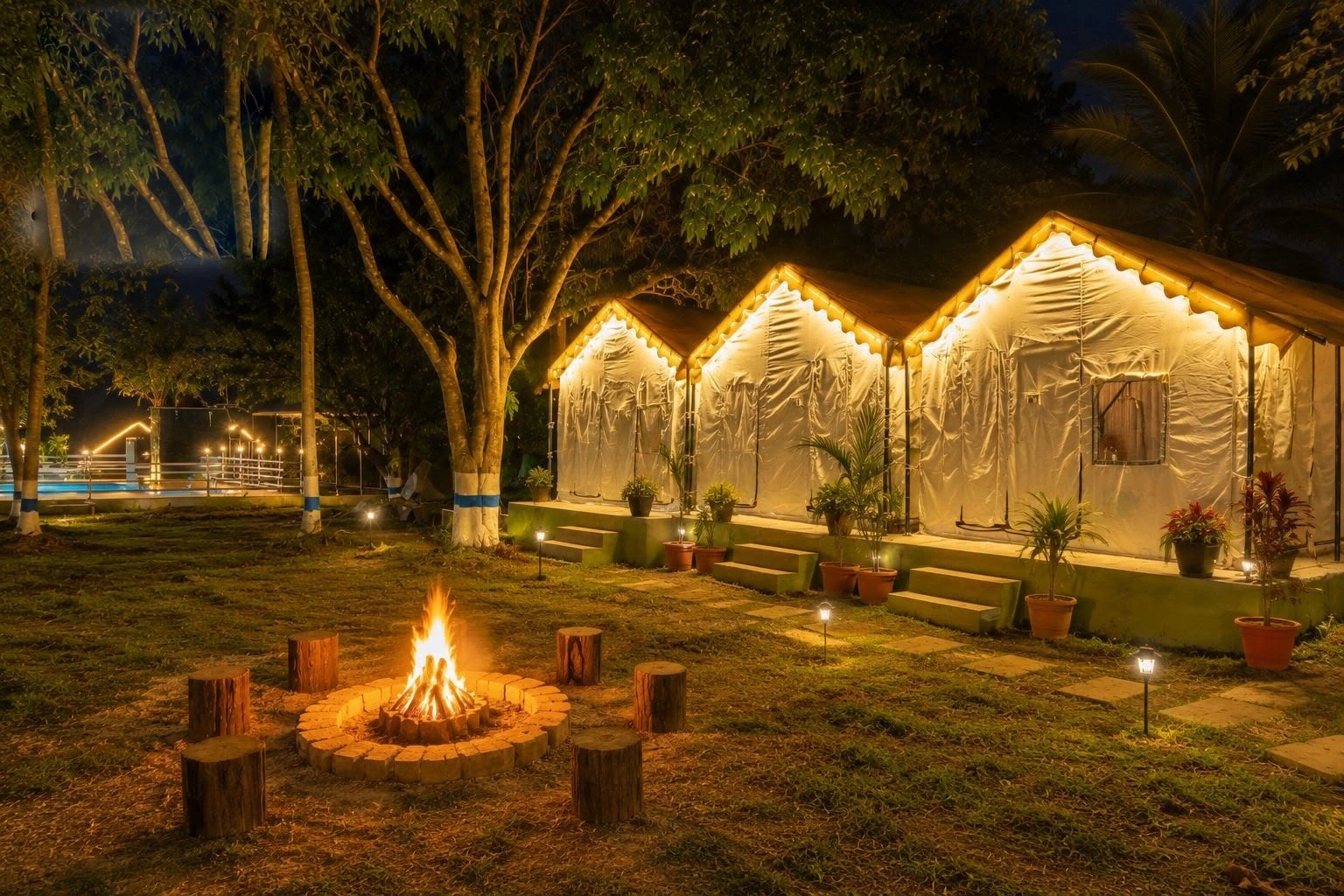 Evening campfire beside tents at Nature Mist Dandeli